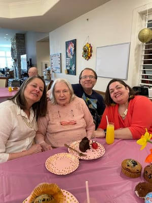 Residents enjoying a celebration with cake and drinks