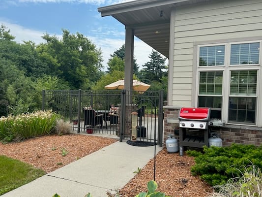 Outdoor patio area with seating and grill