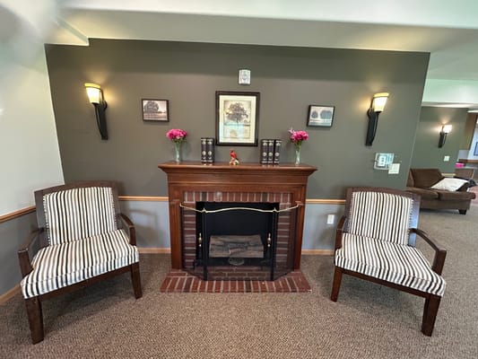 Interior common area with chairs and fireplace