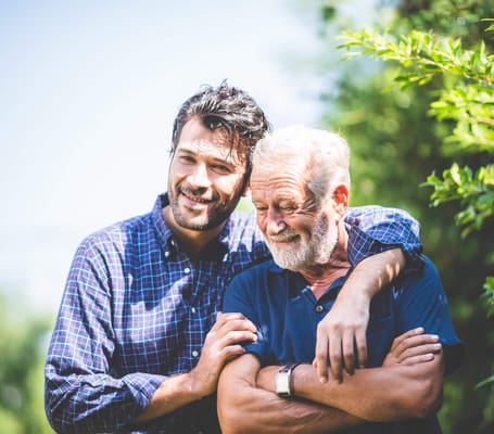Two men enjoying a moment outdoors in a green space