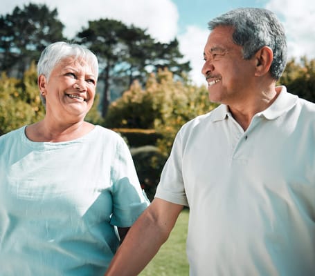 A senior couple smiling in a garden