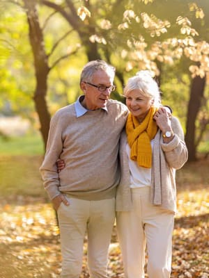 Elderly couple walking together in a park