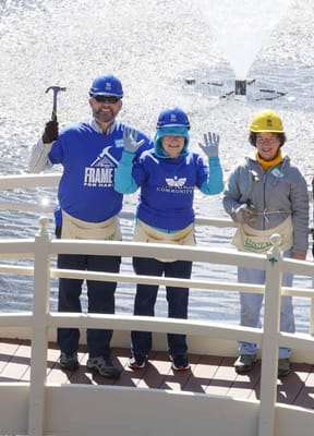 Residents and staff volunteering outdoors near a fountain