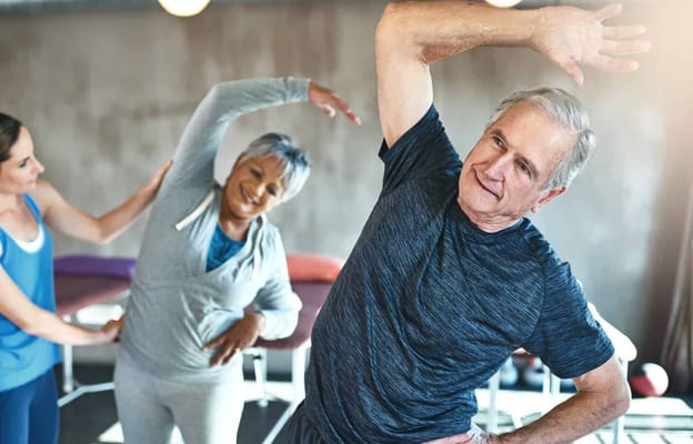 Residents participating in a group stretching activity