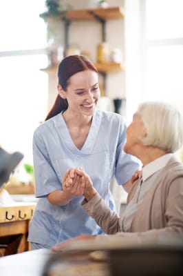 Caregiver interacting with a resident in a cozy setting