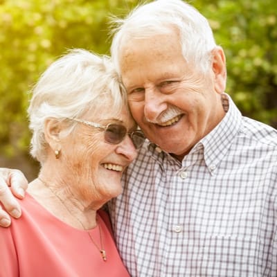 Happy elderly couple smiling together outdoors