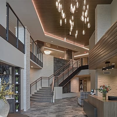 Modern interior lobby with chandeliers and seating areas
