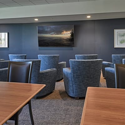 Common area with comfortable seating and a large screen