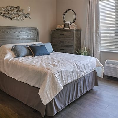 Cozy resident bedroom with a bed and furniture