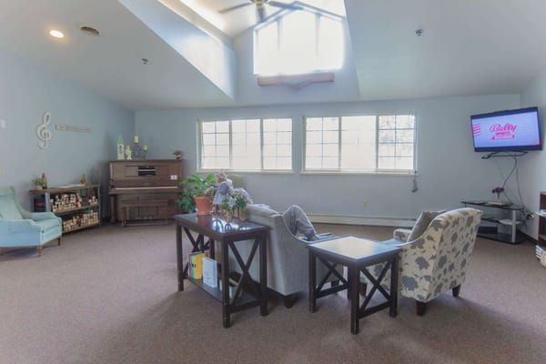 Bright common area with seating and piano