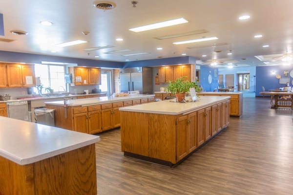 Bright kitchen area with wooden cabinets and countertops