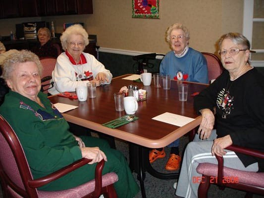Residents engaged in conversation around a table