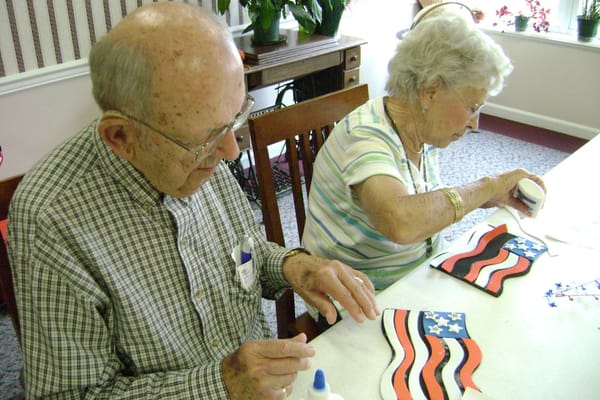 Residents engaged in a craft activity at a table