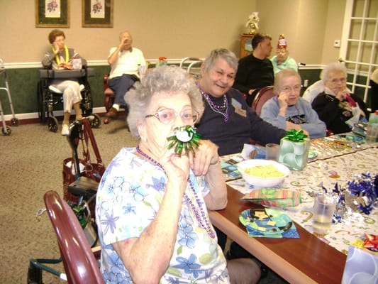 Residents celebrating in a common area with festive decorations