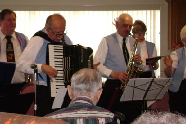 Residents enjoying a music performance in a common area