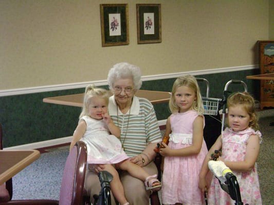 Residents and children smiling together in a common area