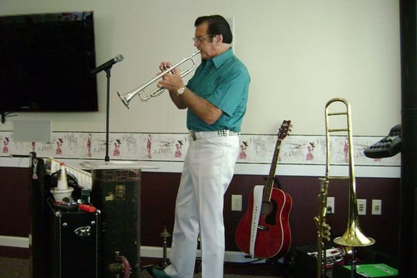 Resident playing trumpet during a musical event
