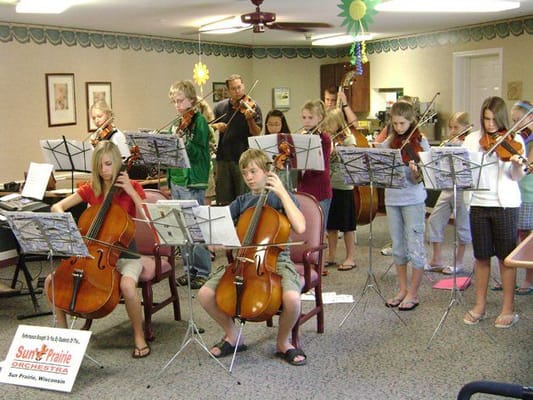 Children performing music in a common area