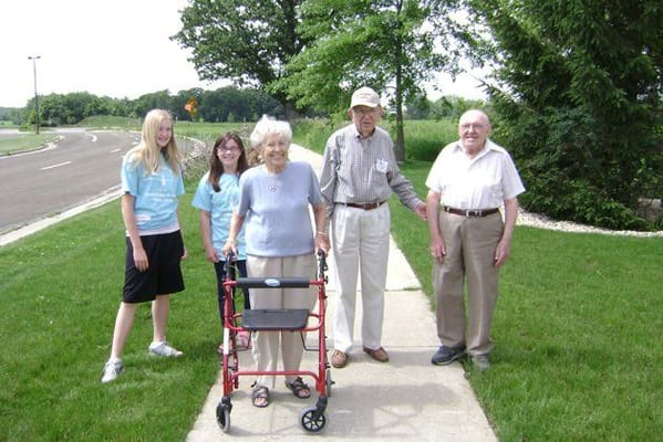 Residents and staff enjoying an outdoor walkway