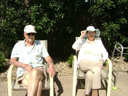 Residents relaxing outdoors on sunny chairs