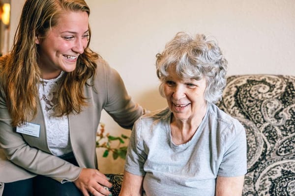Staff member smiling with a resident