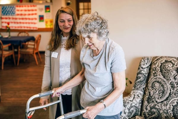 Staff assisting a resident in a common area