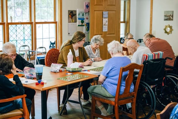 Residents engaged in a bingo game in an activity room