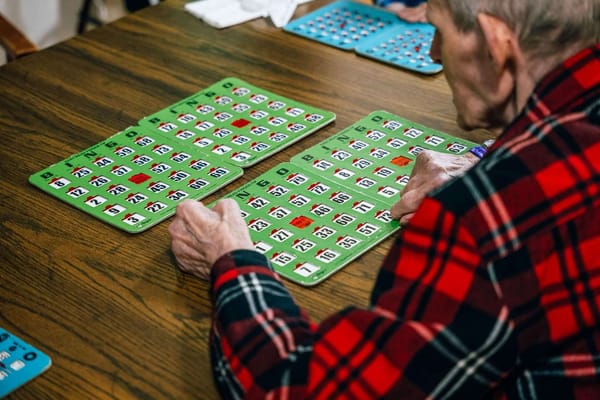 Senior playing bingo at a table