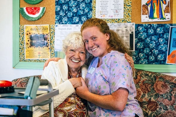 Resident and staff member sharing a joyful moment