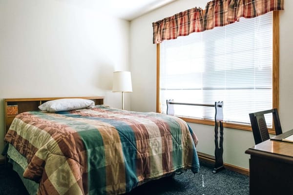 Cozy resident room with a bed and natural light