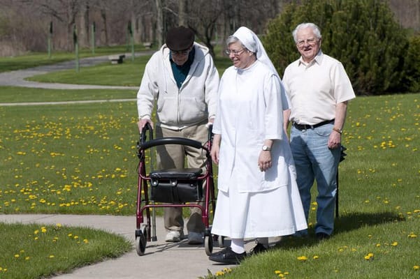 Residents enjoying a walk in a green outdoor area