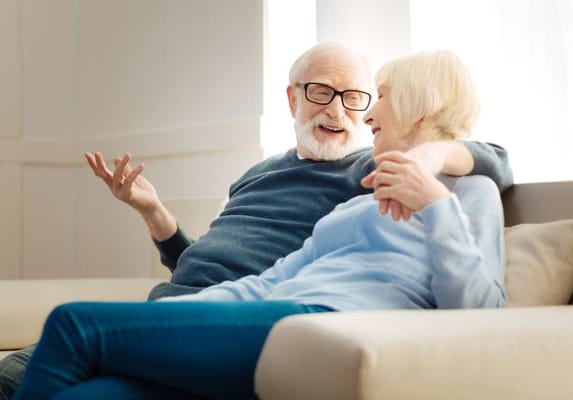 Two residents enjoying a conversation on a couch