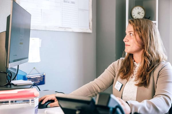 Staff member working at a computer in the office