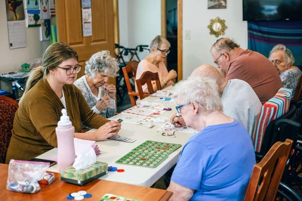 Residents engaging in a bingo game at a communal table