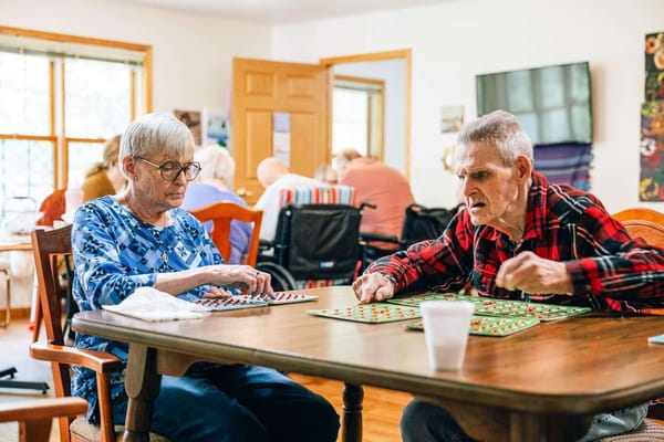Residents engaged in a game of bingo in a common area