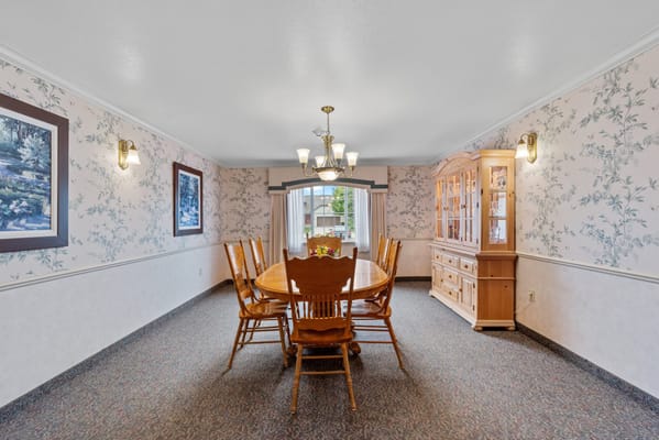Bright dining area with a large wooden table and chairs