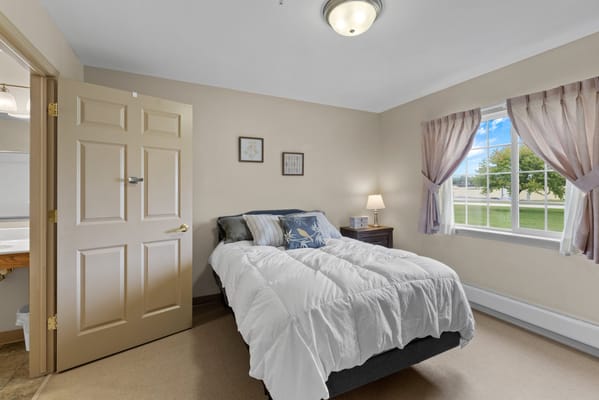 Cozy resident room with a bed and window view