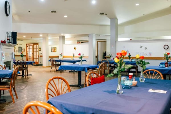 Bright dining area with tables and flower centerpieces