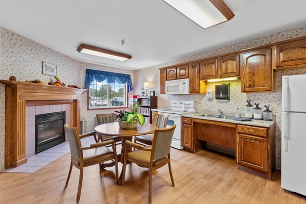 Bright common area with a dining table and kitchen
