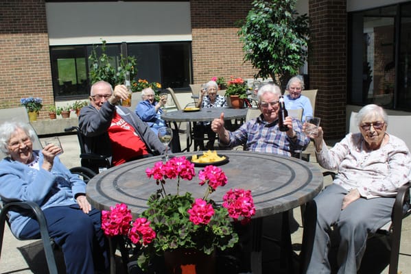 Residents enjoying a sunny day outdoors with snacks