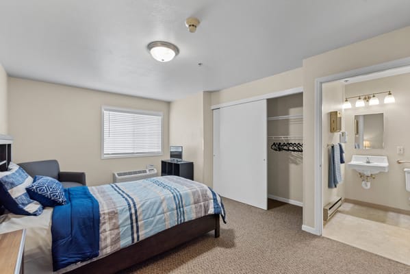 Cozy, well-furnished resident room with bed and bathroom