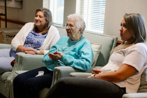 Residents and staff engaged in conversation in a common area