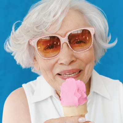 Senior woman enjoying pink ice cream cone