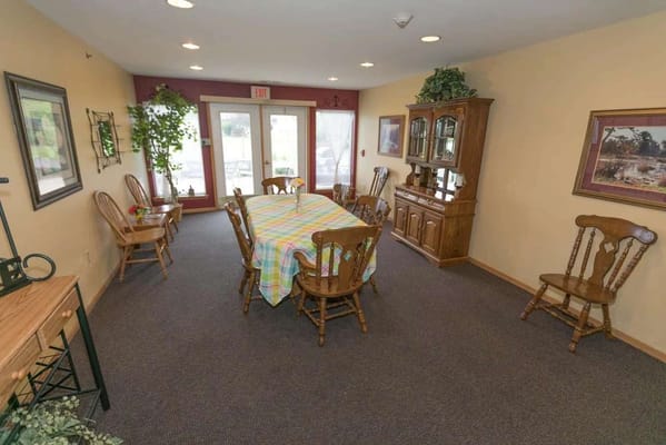 Cozy dining area with wooden furniture and a colorful tablecloth