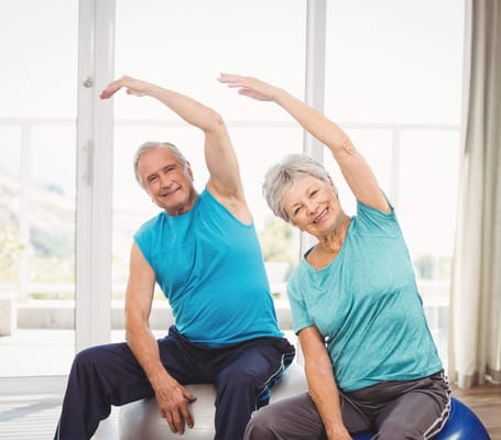 Seniors participating in an exercise class indoors