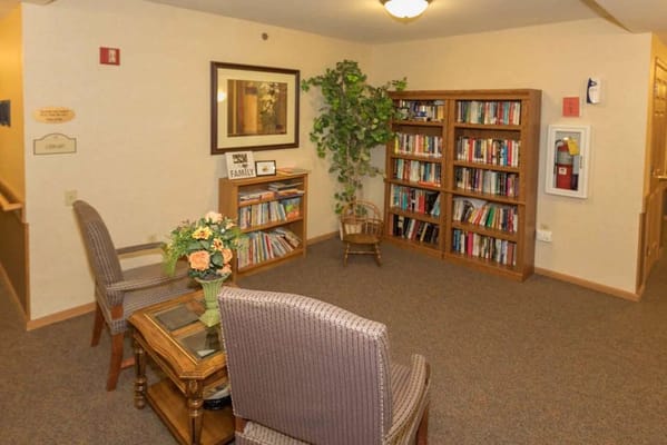 Common area with bookshelves and seating in the facility