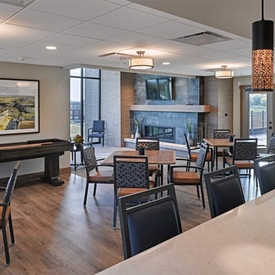 Bright common area with seating and a fireplace