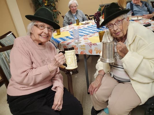 Two residents enjoying drinks in a common area