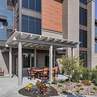 Outdoor seating area with landscaping near the facility