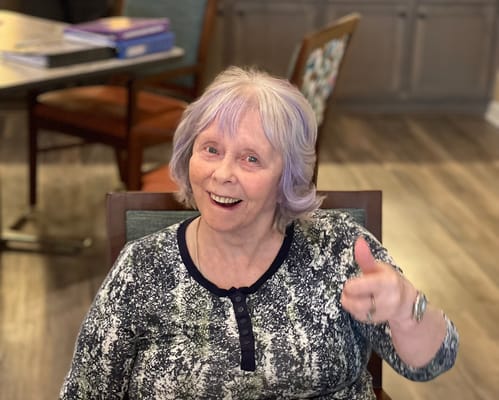 Resident smiling and giving a thumbs up